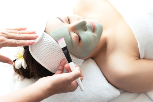 asian woman enjoy relaxing getting during Face peeling mask skin care spa