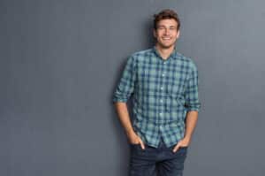 Handsome,Young,Man,On,Grey,Background,Looking,At,Camera.,Portrait