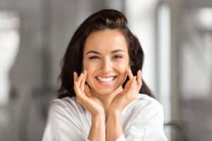 Smiling young woman with beautiful skin after microdermabrasion and chemical peel treatments
