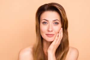 Mature woman with glowing skin after CooLifting cryotherapy treatment.