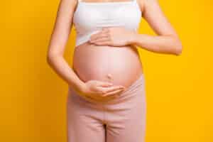 Woman with pregnant belly without stretch marks