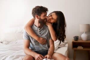Confident man embraced by partner, reflecting the emotional benefits of male enhancement treatments.