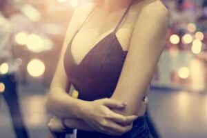 Woman in dress that shows off her lifted breasts after Vampire Breast Lift