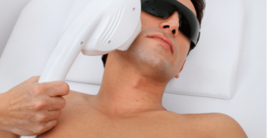 man in laser safety goggles in spa salon